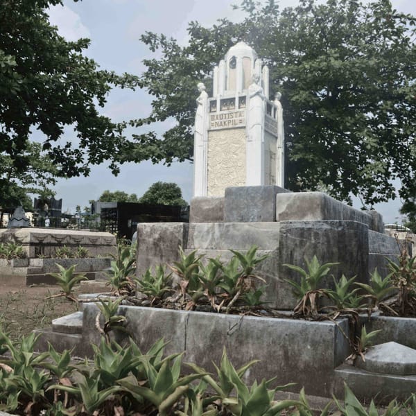 Ornate white mausoleum with "Bautista Nakpil" inscription in Manila cemetery