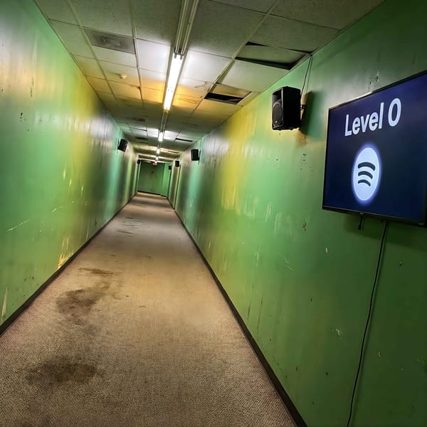 A decaying green corridor with a screen displaying "Level 0" and the Spotify logo