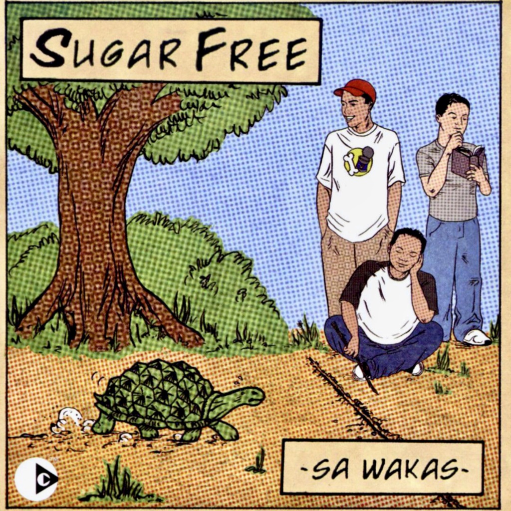 Three people lounging under "Sugar Free" tree with turtle.